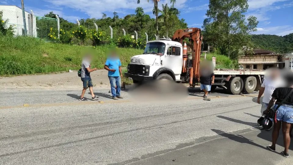 Motociclista vai parar embaixo de roda de caminhão 